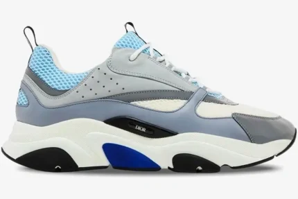 Side profile of a Dior B22 luxury sneaker in white, light blue, and grey with a chunky sole. - SKU 3SN231YXX_H865