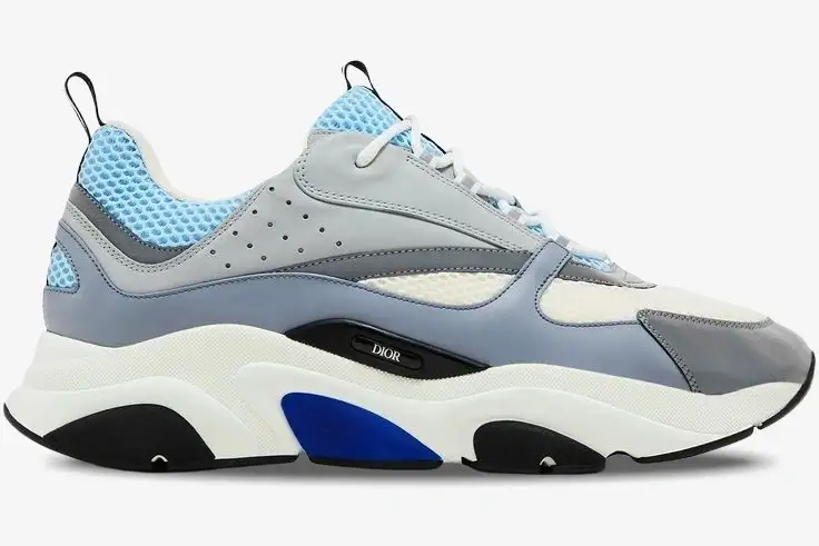 dior-b22-luxury-sneaker-white-blue-side-3sn231yxx-h865 Side profile of a Dior B22 luxury sneaker in white, light blue, and grey with a chunky sole. - SKU 3SN231YXX_H865