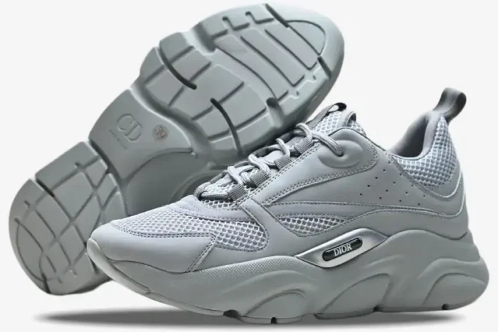 Side profile and sole view of Dior B22 'Triple Grey' luxury sneakers in a monochromatic grey colorway. - SKU 3SN231YKA804