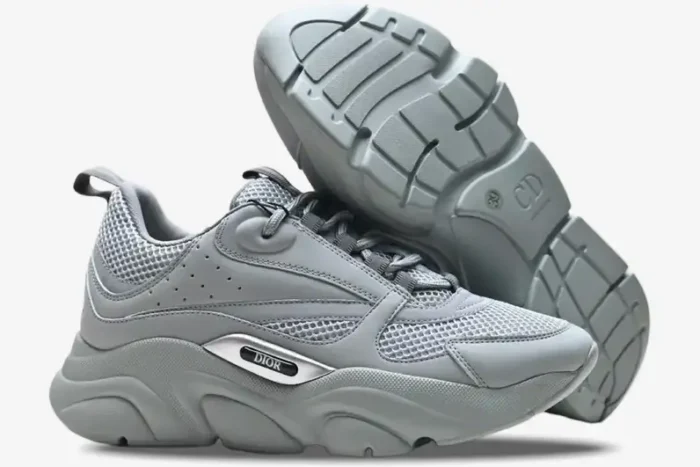 Side profile and sole view of Dior B22 'Triple Grey' luxury sneakers in a monochromatic grey finish. - SKU 3SN231YKA804