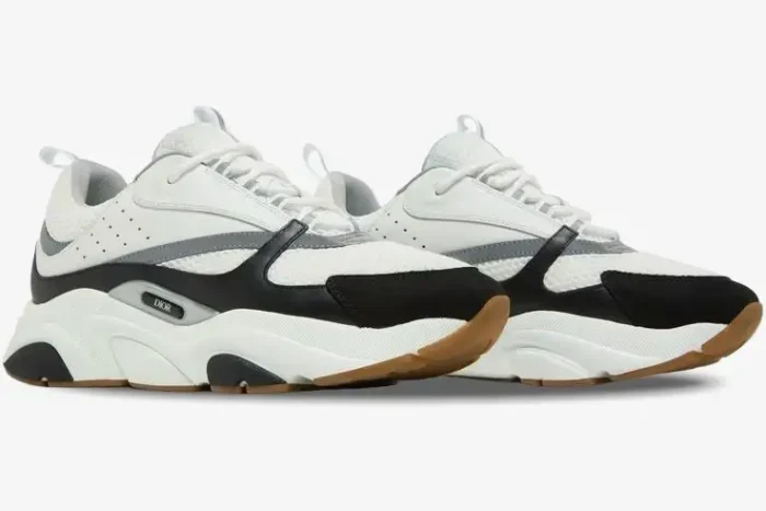 Dior B22 white and black luxury chunky sneakers shown from a side perspective with a thick gum sole. - SKU 3SN231YKB_H968