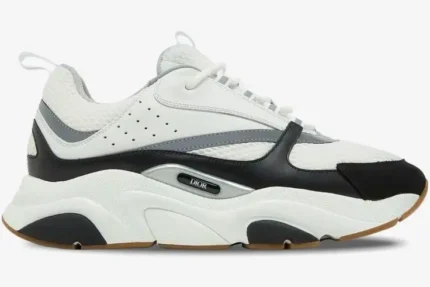 Side view of a Dior B22 luxury chunky sneaker in white and black with a gum sole. - SKU 3SN231YKB_H968