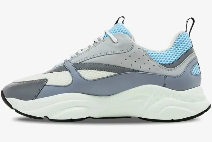 Side profile of Dior B22 'White Blue' luxury sneaker with grey and blue leather panels and a chunky white sole. - SKU 3SN231YXX_H865
