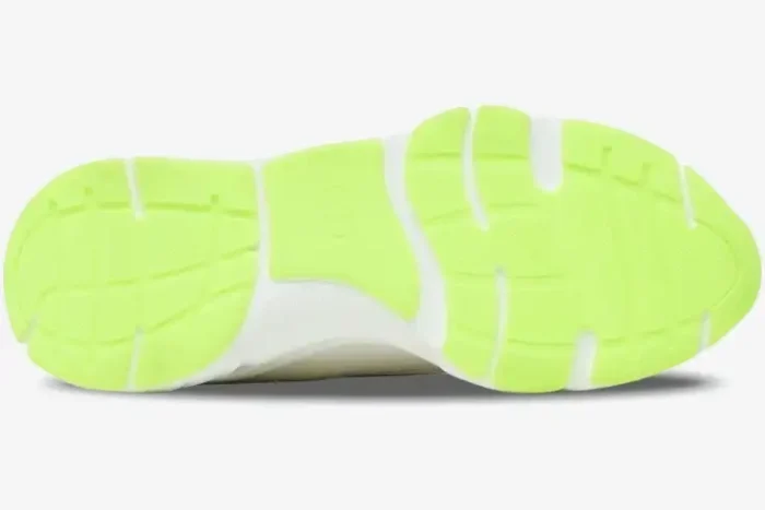 Bottom view of a Dior B22 sneaker featuring a vibrant fluo green rubber outsole with a white midsole. - SKU 3SN231YKA_H000