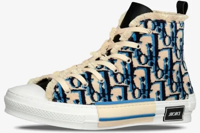 Side profile of a Dior B23 High Top sneaker featuring a blue and beige Oblique pattern with textured fabric. - SKU 3SH129ZGT_H561