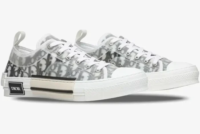 Side view of Dior B23 Low Top sneakers in white and grey oblique canvas with transparent overlays. - SKU 3SN249YJP_H069