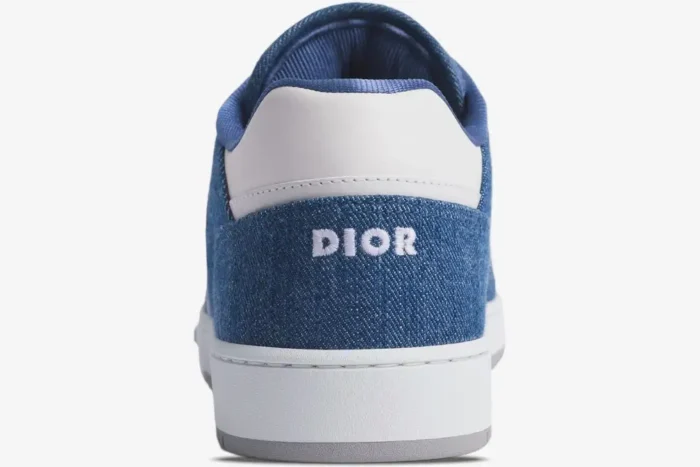 Back view of Dior B27 Low Sneaker featuring blue denim fabric with white embroidered logo and leather heel. - SKU 3SN272ZIR_H565