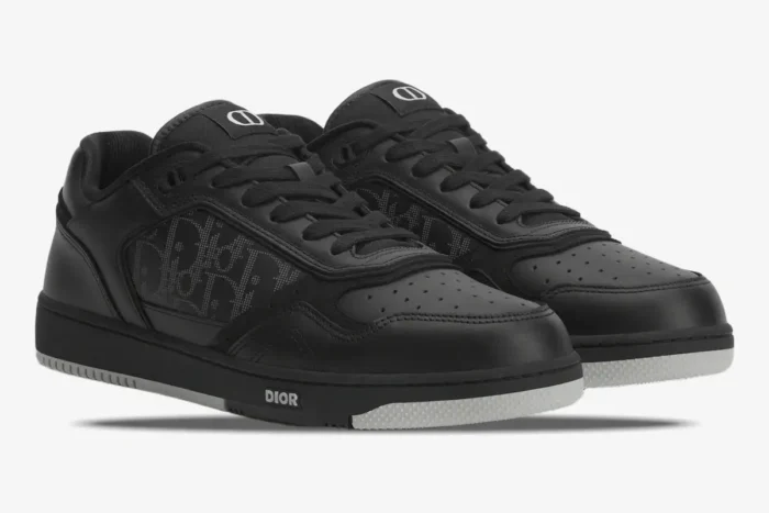 Three-quarter view of Dior B27 low-top sneakers in black Oblique Galaxy leather with white soles. - SKU 3SN272ZPR_H969