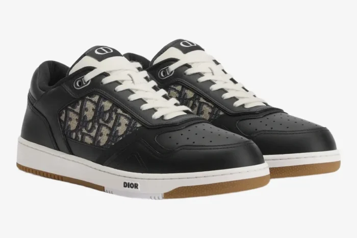 Dior B27 low-top sneakers in black and beige oblique jacquard, three-quarter front view on white background. - SKU 3SN272ZIR_H965