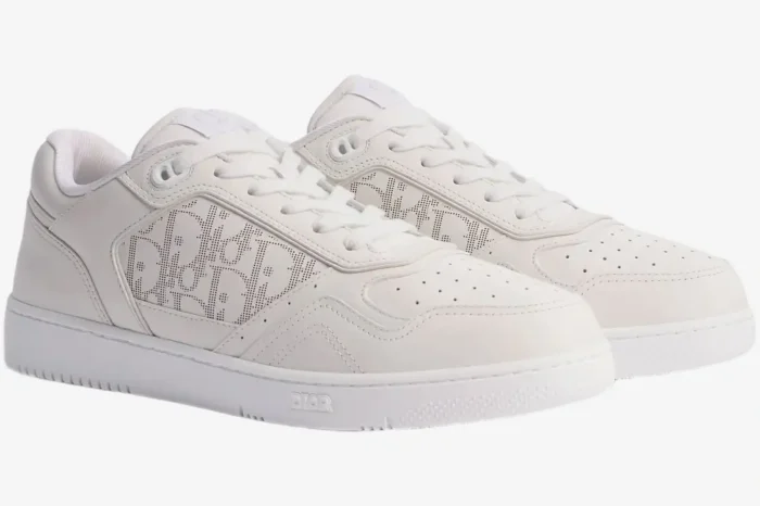 Dior B27 Uptown low-top sneakers in white oblique galaxy leather, shown from a three-quarter angle. - SKU 3SN272ZIR_H060