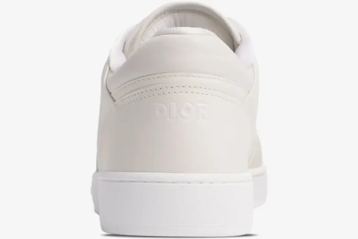 Back view of a white Dior B27 low-top sneaker featuring a debossed logo on the heel. - SKU 3SN272ZIR_H060