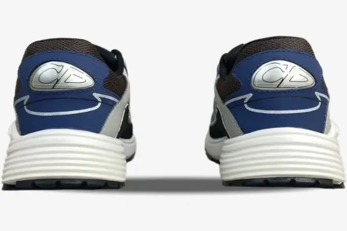 Rear view of Dior B30 sneakers in blue, grey, and black mesh with white ridged soles and CD heel logo. - SKU 3SN279ZRB_H865
