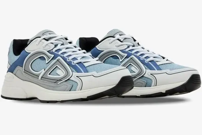 Dior B30 sneakers in light blue, white, and grey, shown from a side perspective. - SKU 3SN279ZRB_H560