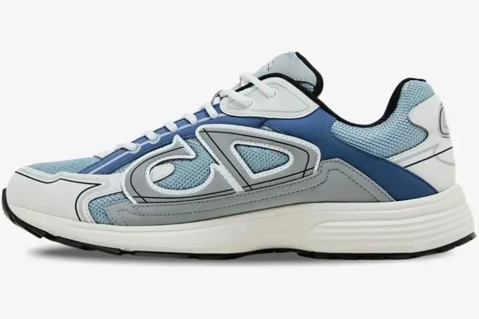 Side profile of a Dior B30 sneaker in light blue, white, and grey with a chunky sole. - SKU 3SN279ZRB_H560