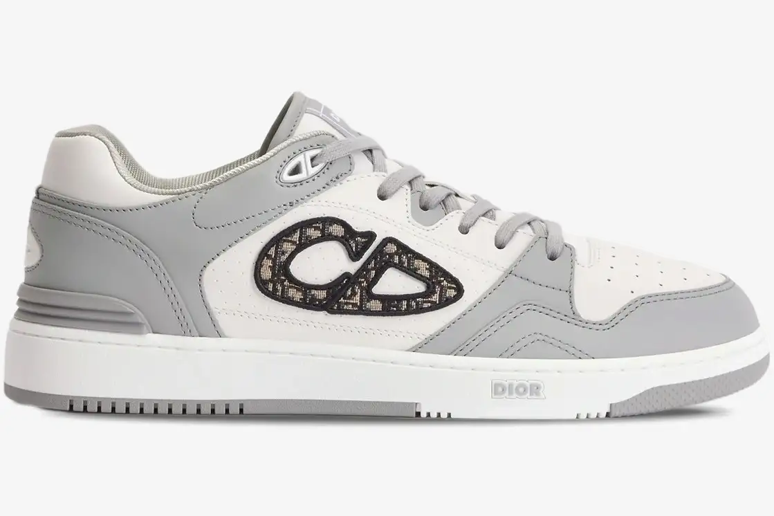 dior-b57-low-top-sneaker-white-grey-side-view-3sn318zxu-h860-519-156 Side profile of a Dior B57 low-top sneaker in white and grey leather with an Oblique CD logo. - SKU 3SN318ZXU_H860