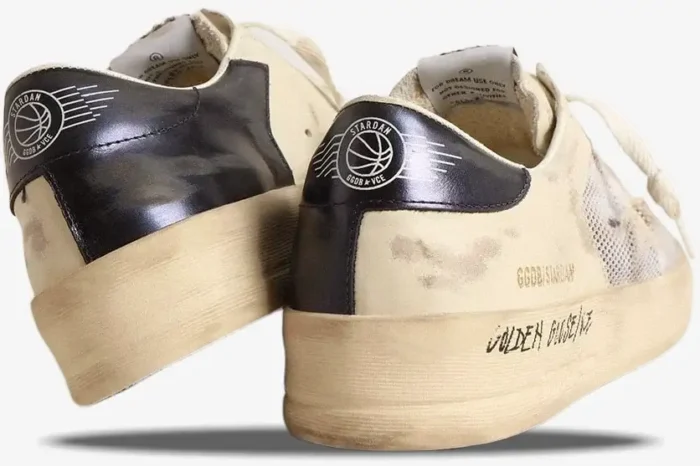 Rear view of Golden Goose Stardan distressed white leather and mesh sneakers with black heel tabs. - SKU GMF00580.F004567.10768