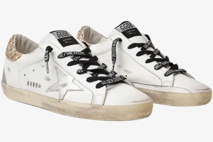 Golden Goose Super-Star sneakers in white with silver star and gold glitter heel, three-quarter view. - SKU GWF00102