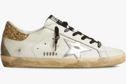 Side profile of Golden Goose Super-Star white leather sneaker with silver star and gold glitter heel. - SKU GWF00102