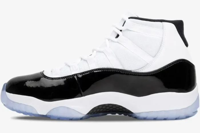 Side profile of Jordan Air Jordan 11 Retro Concord sneakers in white and black with an icy blue sole. - SKU 378037-100
