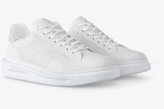 Pair of white Louis Vuitton Beverly Hills leather sneakers with small monogram, three-quarter front view. - SKU 1AHQY3