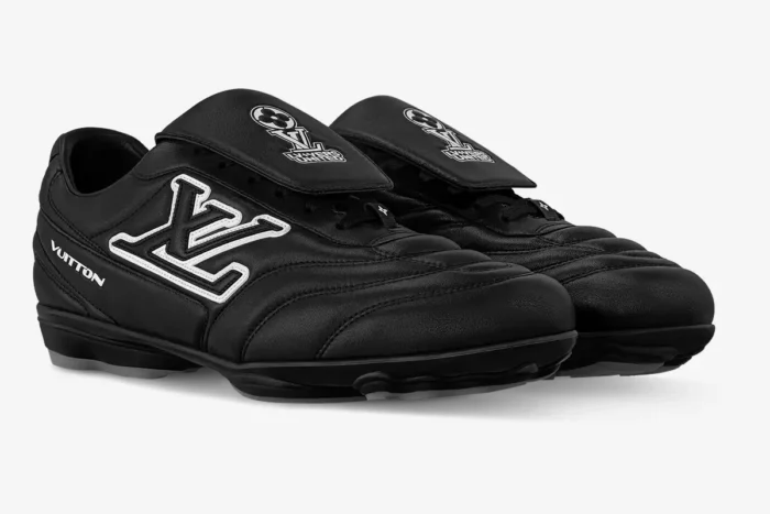 Black Louis Vuitton Footprint soccer shoes with white LV logo, three-quarter front view.