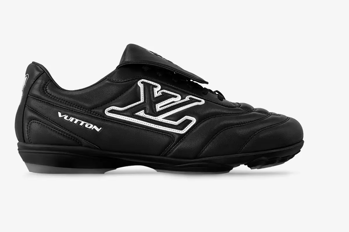 louis-vuitton-footprint-soccer-shoe-black-side-428-313 Side view of a black Louis Vuitton Footprint soccer shoe with white LV logo and Vuitton text.