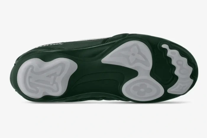 Bottom view of green Louis Vuitton Footprint Soccer Shoes LV+VERS UNITED Edition with monogrammed outsole.