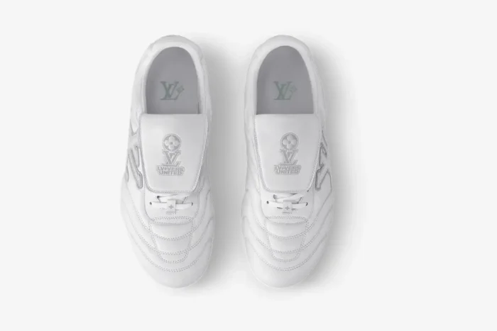 Top-down view of white Louis Vuitton Footprint Soccer Sneakers with embossed logos on the tongues. - SKU 1AFO4A