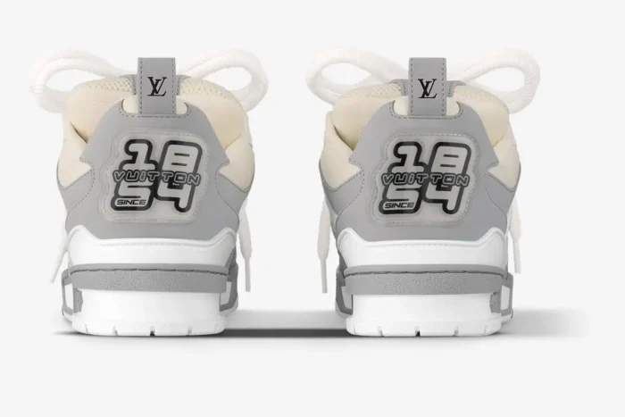 Back view of Louis Vuitton LV Skate sneakers in light grey and white with 1854 branding on the heels. - SKU 1ACQPA