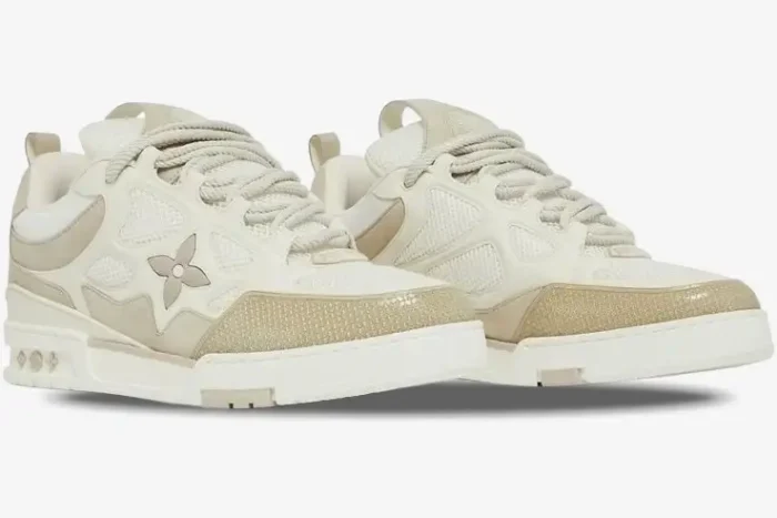 Louis Vuitton LV Skate Sneaker in beige and white, three-quarter front view showing thick laces and mesh panels. - SKU 1AARQS