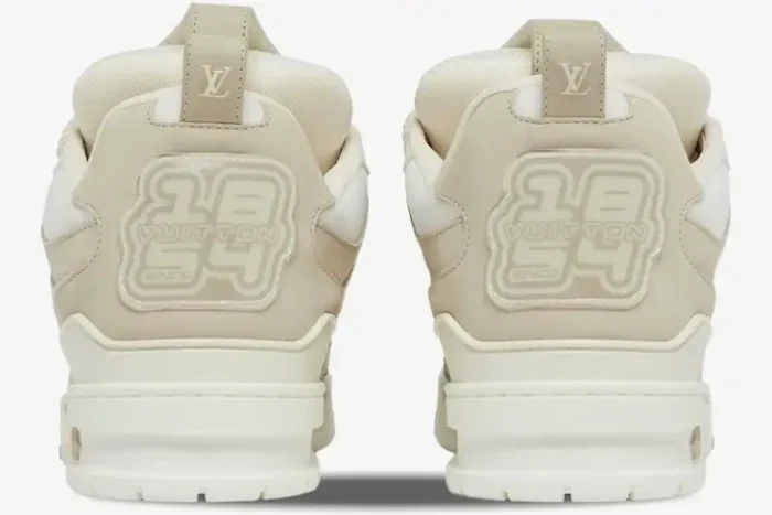 Rear view of Louis Vuitton LV Skate Sneakers in beige and white, showcasing the LV logo and 1854 heel branding. - SKU 1AARQS