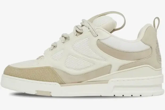 Side profile of a Louis Vuitton LV Skate Sneaker in beige and white with mesh panels. - SKU 1AARQS