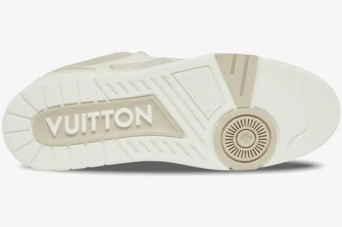 Sole view of a Louis Vuitton LV Skate Sneaker in beige and white, featuring prominent Vuitton branding. - SKU 1AARQS