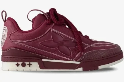 Side view of a Louis Vuitton LV Skate Sneaker in Bordeaux Red with white contrast stitching. - SKU 1ABZ6F