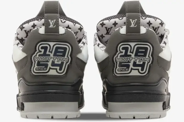 Rear view of Louis Vuitton LV Skate Sneakers in grey, white, and black showing the heel graphic. - SKU 1AC52K