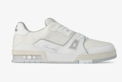 Side profile of white Louis Vuitton LV Trainer #54 leather sneakers with signature script. - SKU 1ADERB