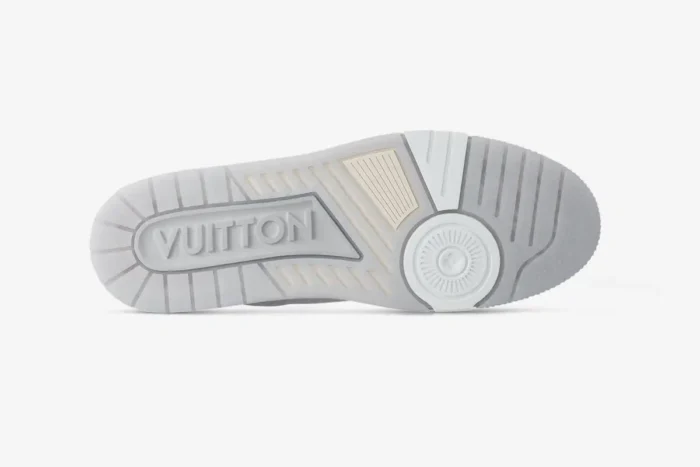 Bottom view of the Louis Vuitton LV Trainer #54 white leather sneaker showing the detailed rubber outsole. - SKU 1ADERB
