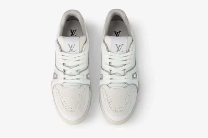 Top-down view of a pair of Louis Vuitton LV Trainer #54 sneakers in white leather with grey accents. - SKU 1ADERB