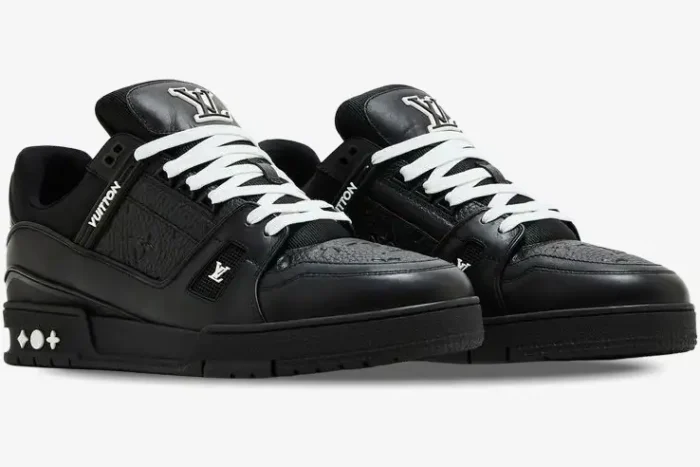 Louis Vuitton LV Trainer Monogram black leather sneakers with white laces, three-quarter front view. - SKU 1A9JG9