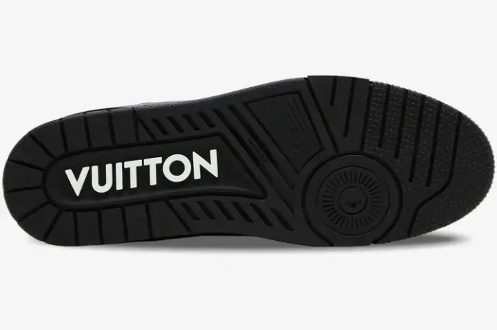 Bottom sole of a black Louis Vuitton LV Trainer sneaker with white VUITTON branding. - SKU 1A9JG9