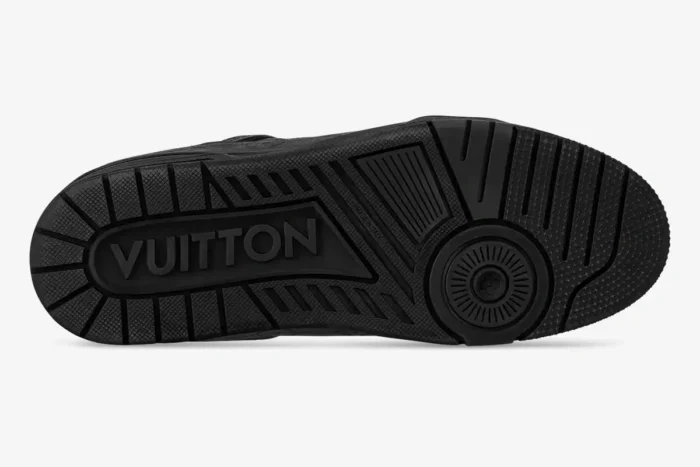 Bottom sole view of a black Louis Vuitton LV Trainer sneaker with embossed branding. - SKU 1AHDBK