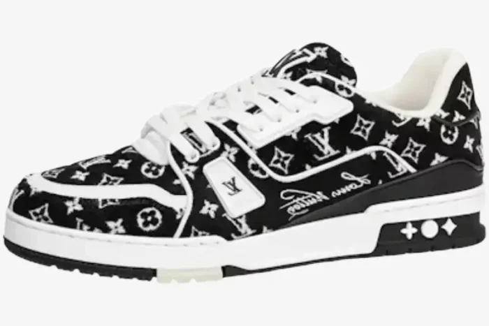 Side view of a black and white Louis Vuitton LV Trainer sneaker with monogram denim pattern. - SKU 1A9JG9
