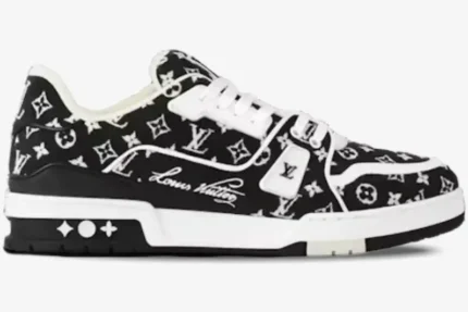 Side profile of a black and white Louis Vuitton LV Trainer sneaker in monogram denim. - SKU 1A9JG9