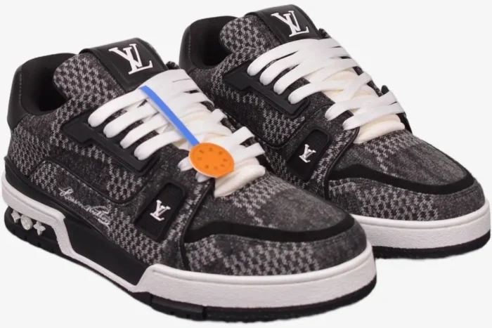 Louis Vuitton LV Trainer in black and white plaid Damier 3D pattern, three-quarter front view. - SKU 1A9ZAY