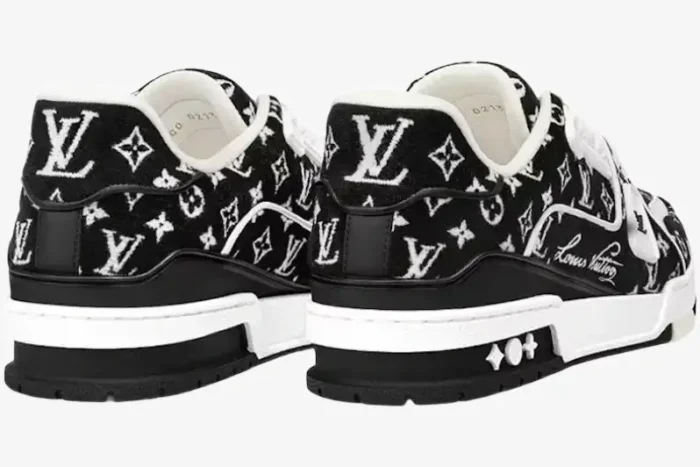 Rear view of Louis Vuitton LV Trainer sneakers in black and white monogram denim. - SKU 1A9JG9