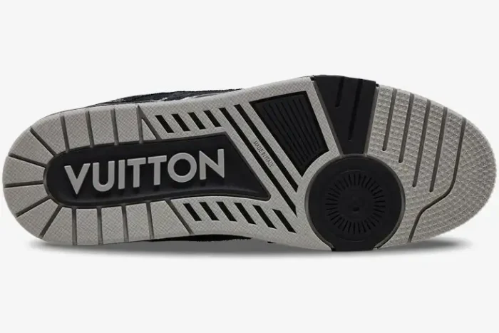 Bottom sole of a black and white Louis Vuitton LV Trainer shoe featuring large Vuitton branding and textured tread. - SKU 1ACFS1