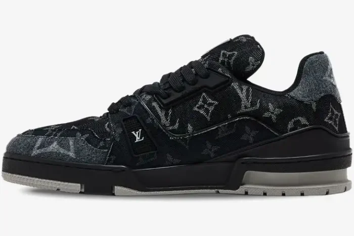 Side view of a black and white Louis Vuitton LV Trainer sneaker with monogram denim pattern. - SKU 1ACFS1