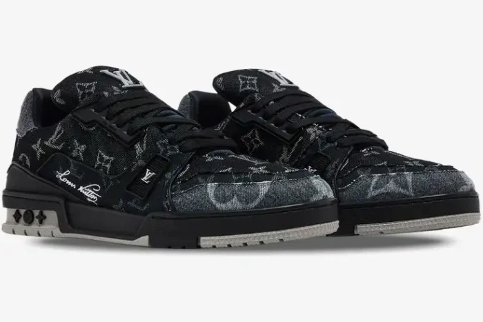 Louis Vuitton LV Trainer Monogram Black White sneakers shown from a front three-quarter angle. - SKU 1ACFS1