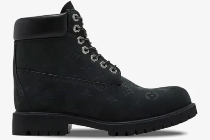 Side profile of black Louis Vuitton x Timberland 6-Inch Ankle Boot featuring embossed monogram patterns. - SKU 1AD73H