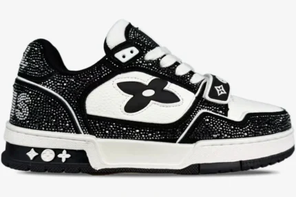 Louis Vuitton Trainer sneaker in black and white with crystal embellishments, side profile view.